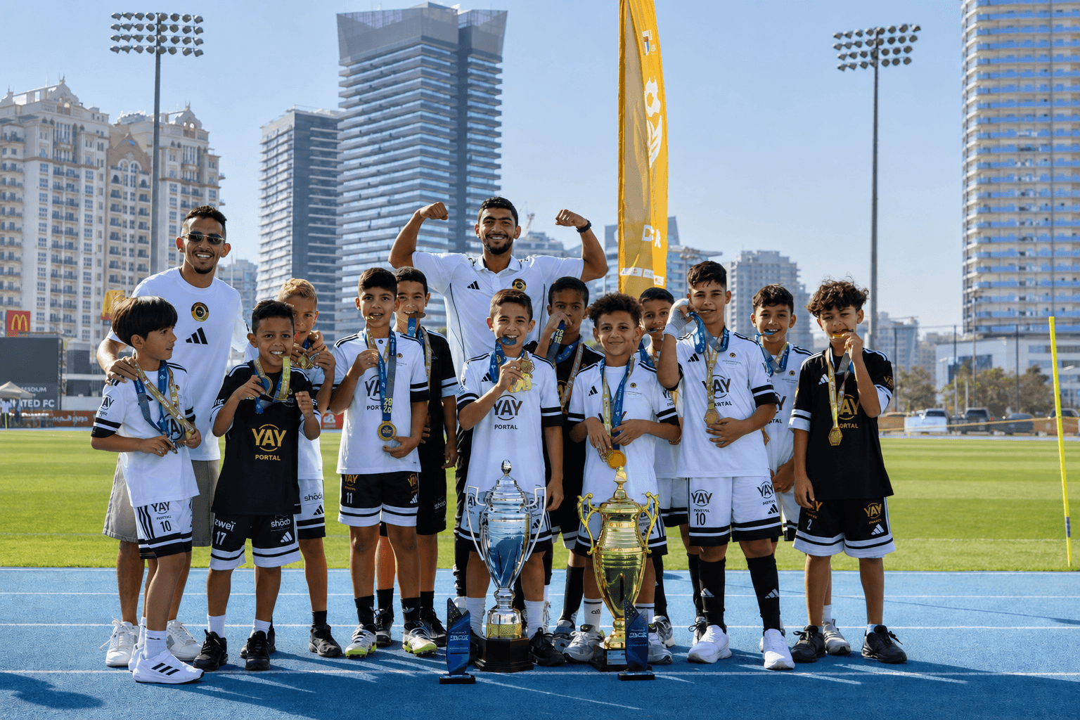 The squad lined up with their trophies and medals, Dubai skyline behind them
